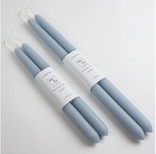 Load image into Gallery viewer, Two sets of light blue taper candles of differing sizes lay on white background and wrapped in white labels