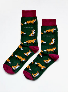 Forest green socks with light maroon cuffs, heels and toes. yellow/orange foxes with white chest/chin and tail tip line the socks. The name Bare Kind is written in white under the first row of foxes. 