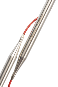 Close up of connection between stainless steel needles and red cables on circular knitting needles; Needles read "ChiaoGoo 11(8.0mm) in light bronze