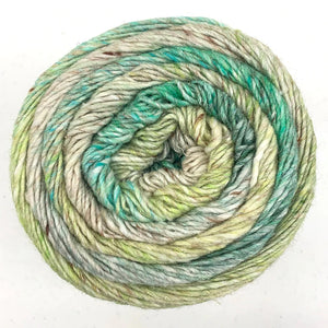 Close up of Noro yarn in color Asugi from top of yarn; Strands in shades of green and tan spiral in a circle on white background