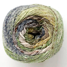 Load image into Gallery viewer, Close up of Noro yarn in color Yachimata; Strands in shades of blue, yellow, green, and brown spiral in circle on white background