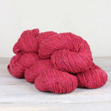 Load image into Gallery viewer, 3 skeins of deep hot pink/salmon yarn with flecks of blue, purple, and yellow throughout on white background.