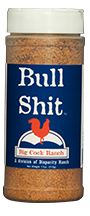 Blue bottle label, white lettering, white cap and red chicken logo. Seasoning name; "Bull shit"
