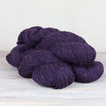 Load image into Gallery viewer, 3 skeins of dark purple yarn with flecks of blue, green, and yellow throughout on white background.