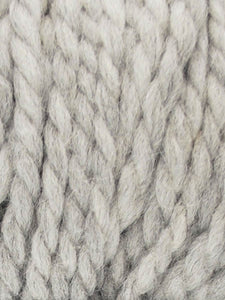 Close up of Jody Long Andeamo yarn in color 002. Strands in shades of white and light gray