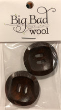 Load image into Gallery viewer, Image of two round dark brown wood buttons in small plastic package that reads &quot;Big Bad Wool.&quot; Each button has two long holes in middle