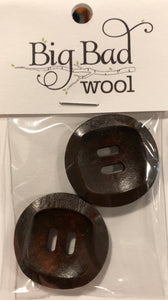 Image of two round dark brown wood buttons in small plastic package that reads "Big Bad Wool." Each button has two long holes in middle