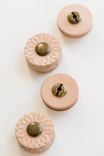 Load image into Gallery viewer, Four post buttons shown on white background with every other button flipped over to show back side; Front side of buttons show light tan flower petal-like design with round bronze colored middle; Back side of buttons show light tan with no design and round bronze colored middle piece with small hole in middle and black line running across