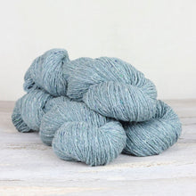 Load image into Gallery viewer, 3 skeins of light blue yarn with flecks of white on white background.
