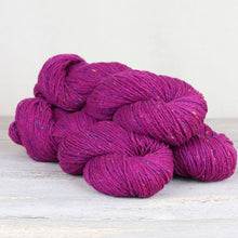 Load image into Gallery viewer, 3 skeins of bright hot pink yarn with flecks of blue, yellow, and red throughout on white background.