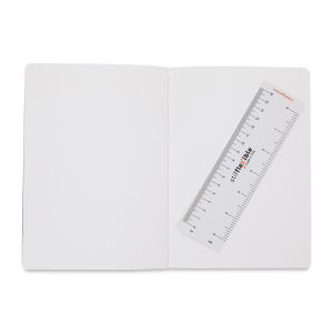 Image of inside of artwork pad open to two blank pages with ruler resting on right side page