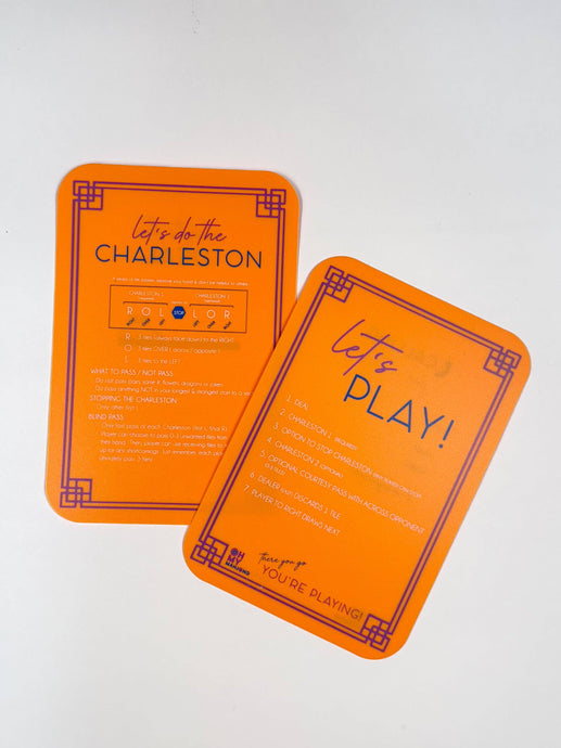 Two orange playing cards with text on a white background