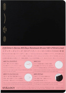 Black notebook with pink back cover featuring text and graphics, Stélology brand visible