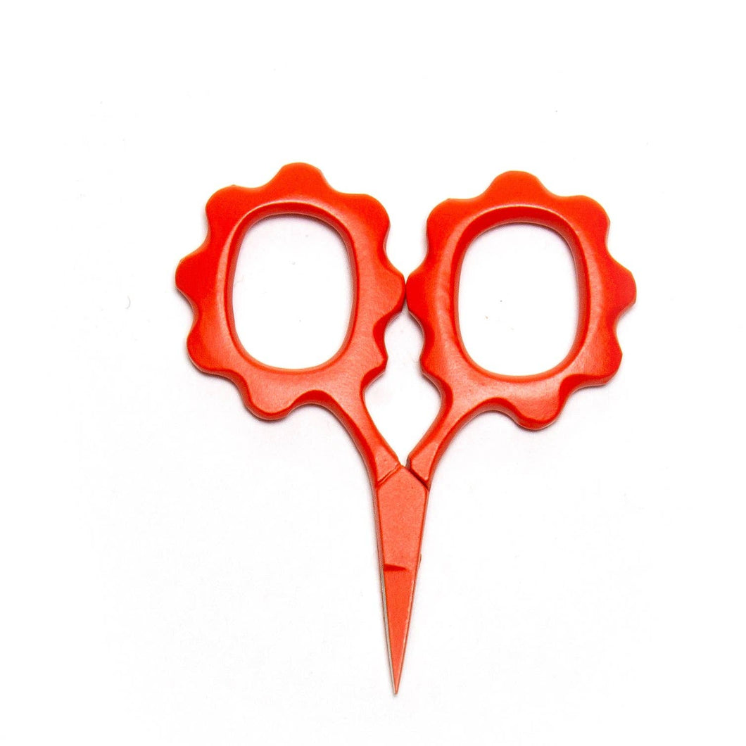 Red scissors with decorative handles on a white background