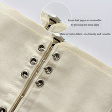 Load image into Gallery viewer, Close-up of a beige fabric notebook with metal clips, showing loose-leaf pages and cotton material.