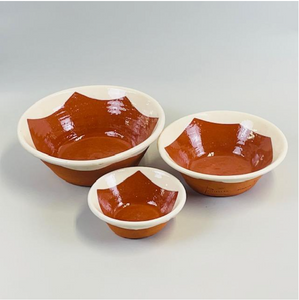 Image of 3 bowls in small, medium, and large with the centers being dark orange/brown with pointed scalloped edges and white around the rims