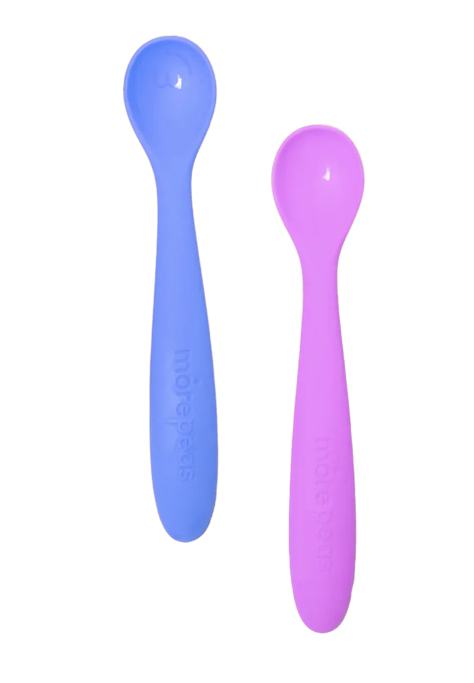A dark blue and light purple silicone baby spoon on white background