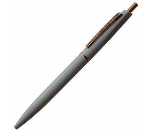 Pearl grey ball point pen with gold ring in the middle of the pen, gold clip and button.