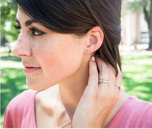Load image into Gallery viewer, Woman with brown hair shows small white circle studded earrings