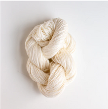 Load image into Gallery viewer, Cream colored yarn twisted up on white colored background