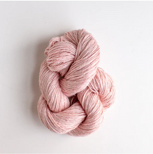 Load image into Gallery viewer, Blush pink colored yarn twisted up in front of white background