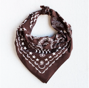 Brown bandana with white crescent moons, swirls, stars, and line-work designs