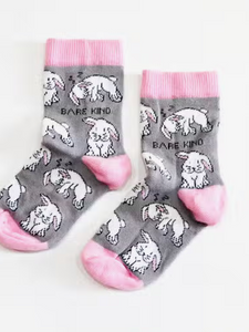 Light grey socks with baby pink cuffs, heels and toes. White rabbits, some sleeping, line the socks. The name Bare Kind is written in black under the first row of rabbits.