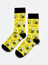 Load image into Gallery viewer, Yellow socks with black cuffs, heels and toes. Yellow and black bees with white wings line the socks. The name Bare Kind is written in black under the first row of bees.