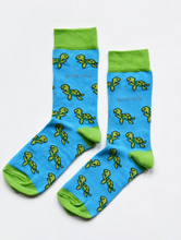 Load image into Gallery viewer, Aqua blue socks with lime green cuffs, heels and toes. Lime green turtles line the socks. The name Bare Kind is written in grey under the first row of turtles. 