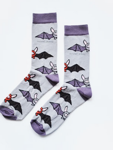 Light blue socks with light purple cuffs, heels and toes. Alternating rows of purple/blue and red/black bats line the socks. The name Bare Kind is written in grey under the first row of bats. 