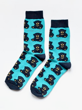 Load image into Gallery viewer, Turquoise socks with navy blue cuffs, heels and toes. Navy blue bears with tan snouts and paw pads line the socks. The name Bare Kind is written in tan under the first row of bears. 