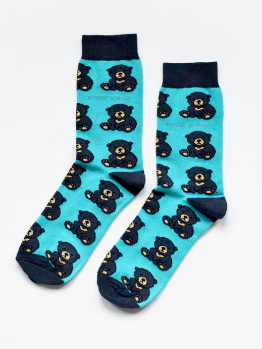 Turquoise socks with navy blue cuffs, heels and toes. Navy blue bears with tan snouts and paw pads line the socks. The name Bare Kind is written in tan under the first row of bears. 