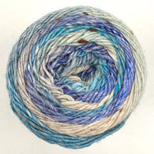 Load image into Gallery viewer, Close up of Noro yarn in color Ashiya from the top of yarn; Strands in shades of blue, brown, and tan spiral in a circle on white background