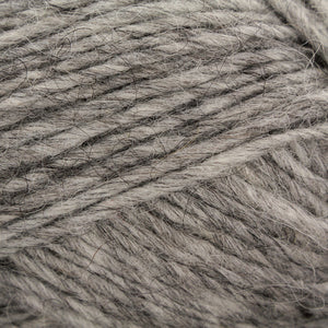 Close up of yarn color 0056. Shades of light and dark gray running through strands