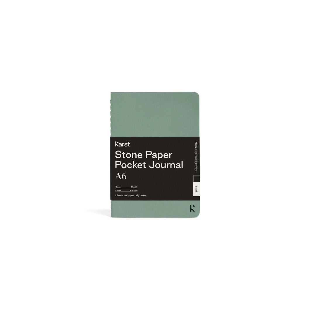 Small light green journal on white background with black paper wrap covering middle section; Black wrap reads 
