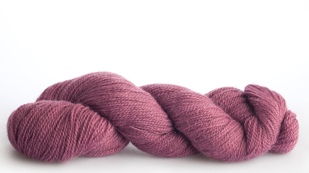 Isager Alpaca 2 Yarn in color 19 laid out on white background. Yarn in shades of purples and pinks
