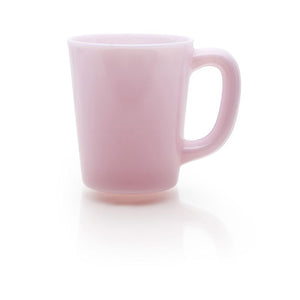 Smooth light pink glass with handle pictured on white background; Bottom of glass reflected back off of white background below glass, light reflecting off of handle