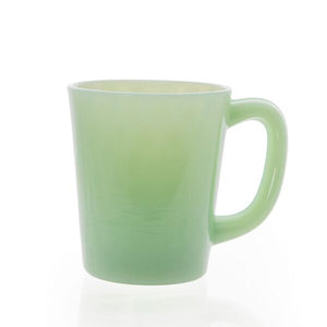 Smooth light green glass with handle pictured on white background; Light shown reflecting off of handle 