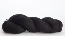 Load image into Gallery viewer, Isager Alpaca 2 yarn in color 30 laid out on white background. Color 30 is mostly black and shades of dark gray