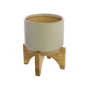 One HomArt Ames Cachepot in light gray with dark speckles throughout sitting on wooden stand against white background