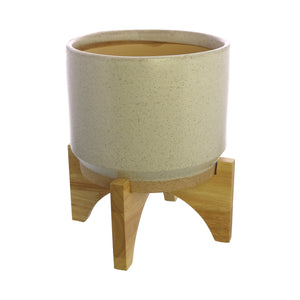 One HomArt Ames Cachepot in light gray with dark speckles throughout sitting on wooden stand against white background