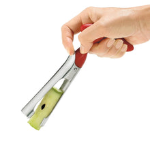 Load image into Gallery viewer, Apple corer with green apple core in middle being held in hand on white background