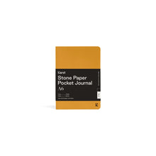Load image into Gallery viewer, Small yellow journal on white background with black paper wrap covering middle section; Black wrap reads &quot;KARST&quot; &quot;Stone Paper Pocket Journal&quot; &quot;A6&quot; in white on right side; Small black &quot;K&quot; stamped in bottom right corner of cover