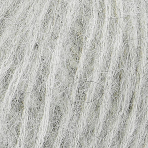 Close up of Rowan Alpaca Classic yarn color 101. Strands in shades of gray and white