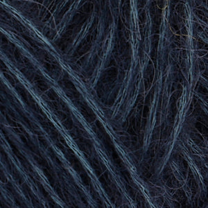 Close up of Rowan Alpaca Classic in color 104. Strands in shades of light and dark blue