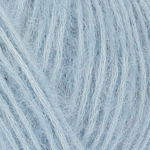 Close up of Rowan Alpaca Classic color 106. Strands in shades of white and light blue