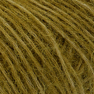 Close up of Rowan Alpaca Classic yarn in color 111. Strands in shades of light and deep yellow