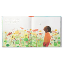 Load image into Gallery viewer, Opened page of children&#39;s book All That I Am. Right side of book shows young black boy in orange shirt and red pants in a field of flowers on a white background. He stares up at a small sketch of a gray butterfly. Left side of page continues on field of flowers in greens, yellows, oranges, and blues, with writing above on white background