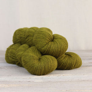 The Fibre Co. Amble yarn in color Helvellyn. Strands in shades of green and yellow