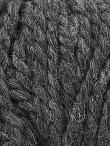Close up of Jody Long Andeamo yarn in color 001. Strands in shades of light and dark gray